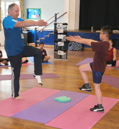 A pupil taking part in a demonstration with Michael, our yoga instructor